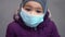 Toddler child wearing face medical mask outdoors in cold weather. air pollution pm2.5 or covid-19 pandemic