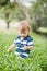 Toddler crawling in the garden and exploring backyard