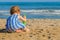 Toddler digging on the beach