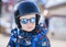 Toddler Dressed Safely for Skiing with Helmet, Harness & Sunglasses