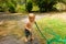 A toddler drinking water from a hose