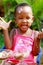 A toddler enjoying ice-cream on a sunny afternoon