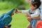 toddler feeding blue-and-yellow macaw (Ara ararauna) bird on hand