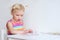 Toddler girl assembling jigsaw puzzle indoors