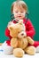 Toddler girl caring for her teddy bear with a stethoscope