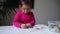 Toddler girl drawing with colourful markers. Preschool child homeschooling at home. Developing creativity skills.