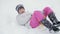 Toddler girl going down a sledge on a snowy hill