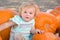 Toddler Girl Having Fun in a Rustic Ranch Setting at the Pumpkin Patch