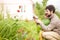 Toddler girl and her father watering the garden and having fun