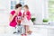 Toddler girl and her mother making fresh strawberry