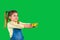 A toddler girl looks to the side and holds out a domestic lizard on a green background with side space for your