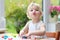 Toddler girl making cookies from plasticine