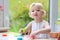 Toddler girl making cookies from plasticine