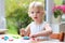 Toddler girl making cookies from plasticine