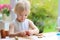 Toddler girl making cookies from plasticine