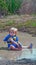 Toddler Girl Playing in Mud Puddle