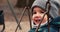 Toddler girl playing outside in a Toronto park on a winter day.