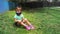 Toddler girl sitting in the grass sad 