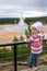 Toddler girl standing at Grand Prismatic Spring overlook, Midway Geyser Basin, Yellowstone National Park, Wyoming, USA