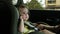 Toddler girl yawns in dark green child car safety seat