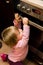 Toddler gripping kitchen oven door