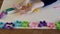 Toddler hands playing colorful play dough with plastic molds and rolling pin