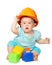 Toddler in hardhat plays with blocks