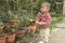 Toddler help watering flower pots