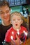 Toddler helping blow out Birthday candles