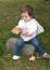 Toddler holding a big leaf she found