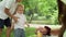 Toddler holding bottle with soap bubbles. Father and children having picnic