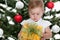 Toddler holding a christmas presen