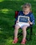 Toddler holding a sign saying Daddy I love you