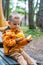 Toddler Holding Small Carved Pumpkin