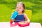 Toddler kid girl drinking eating pasta in garden