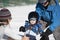 Toddler Learns to Ski with Dad While Mom Watches. Dressed Safely