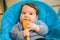 Toddler licking a spoon. A child looks at an empty wooden spoon. when teeth are cut. gums itch