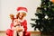 Toddler and newborn baby, siblings disguised as christmas, holiday concept