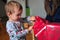 Toddler opening wrapped Christmas gift