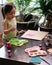 Toddler painting on the recycled cardboard at home