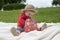 Toddler palying outdoors with memo cards