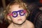 Toddler with pipe cleaner glasses