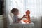 Toddler playing with baby doll singing doll out of the cup,in re