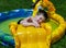 Toddler playing in blow up pool