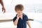 Toddler Playing with his Lip on a Boat