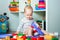 Toddler plays colorful home constructor and copy space. Development of children from birth