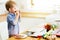 Toddler preparing food in kitchen