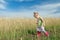 Toddler preschooler blonde girl going down dirt road among farm field