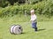 Toddler pushing water barrel