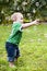 Toddler reaching for soap bubbles